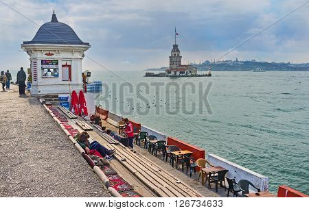 ISTANBUL TURKEY - JANUARY 21 2015: The cozy teahouse on the Uskudar embankment offers the hot beverages and scenic view on Bosphorus and the Maiden's Tower on January 21 in Istanbul.