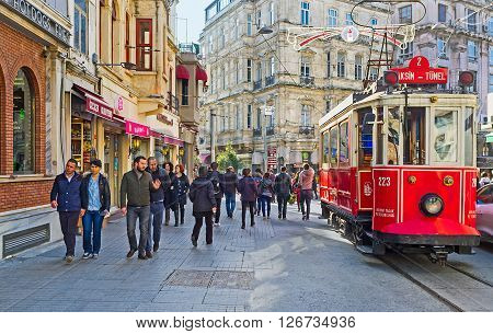 ISTANBUL TURKEY - JANUARY 22 2015: The old red tram in Istiklal Caddesi (Independence Avenue) the central shopping street of the city on January 22 in Istanbul.