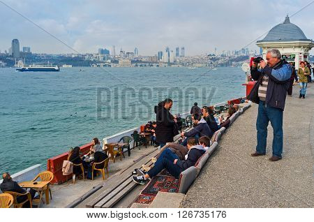 ISTANBUL TURKEY - JANUARY 21 2015: The tourist makes pictures of Bosphorus from the Uskudar embankment on January 21 in Istanbul.