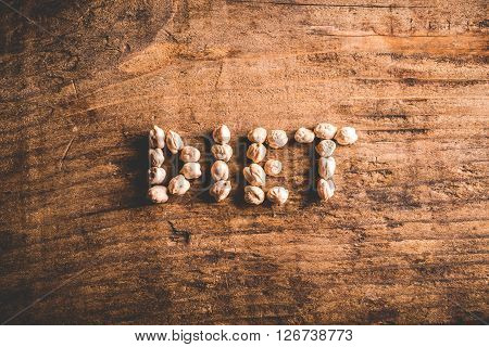 diet written with chickpeas on wood background