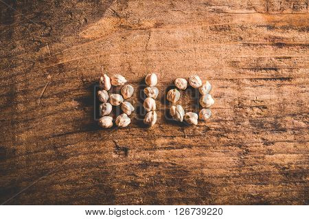 bio written with chickpeas on wood background