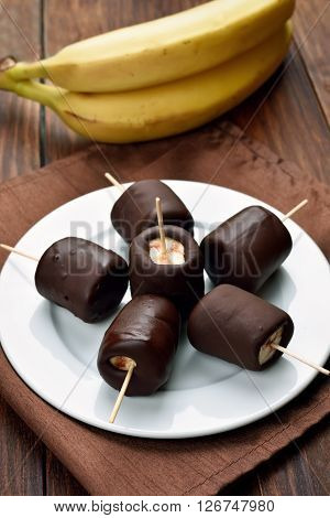 Fruit summer dessert frozen banana covered with chocolate