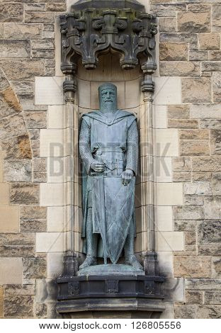 A statue of Sir William Wallace on the facade of Edinburgh Castle in Scotland.