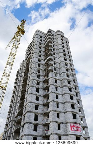 Construction of multistorey residential building with a poster on the wall: 