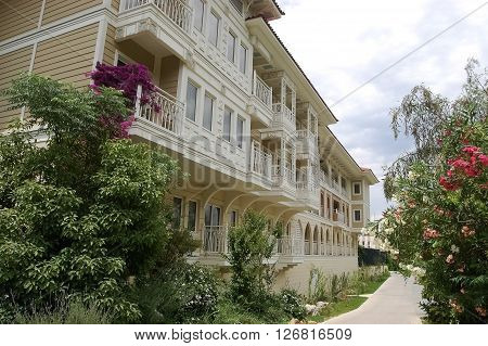 Side, ANTALYA, TURKEY - JUNE 02, 2015: Original building and walkway with flowers in high class hotel Ali Bey Resort, Turkey.