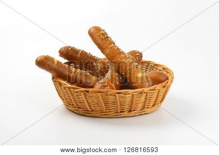 scuttle of fresh bread rolls on white background