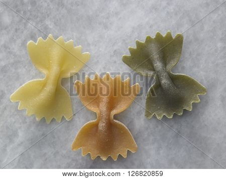 dry farfalloni pasta on the marble top