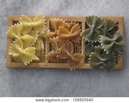 dry farfalloni pasta on the marble top