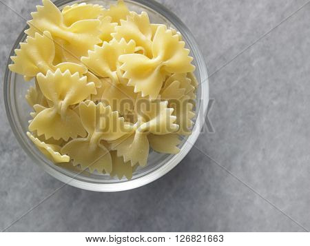 dry farfalloni pasta on the marble top