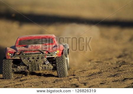 Low angle shot of an RC car kicking up dust