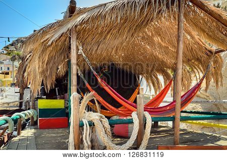 Hammocks with palm roof at Matala beach, Crete island