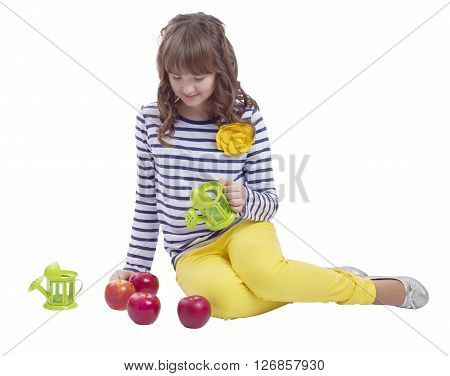 Pretty teengirl sitting with watering can and apples on white background
