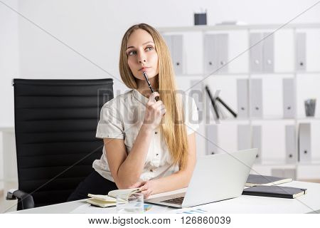 Thinking Businesswoman With Notebook