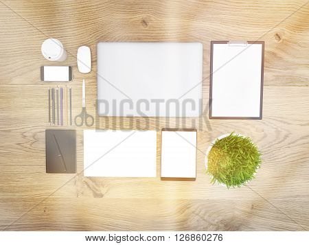 Topview of wooden desktop with closed laptop small plant and other office tools. Toned image. Mock up 3D Rendering