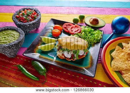 Gordita mexican fried puff corn taco filled with pastor meat lettuce and cream