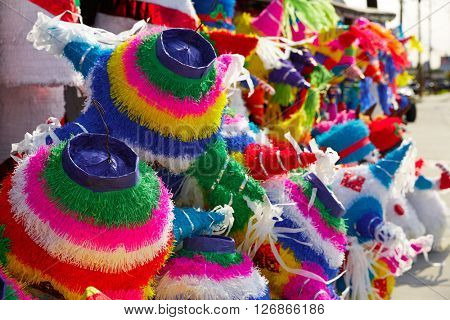 Mexican party pinatas decorated with fringed tissue colorful paper