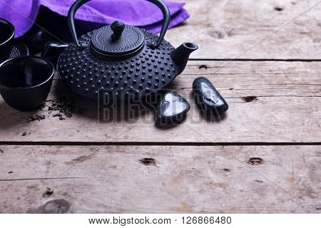 Traditional asian tea set on aged wooden background. Selective focus. Place for text.