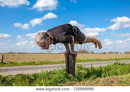 on an sunny day this man enjoys Ayurveda and yoga in nature