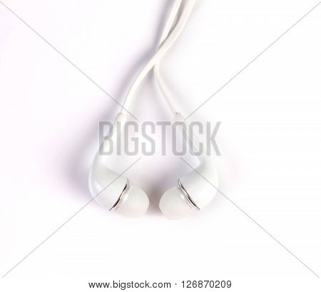 the white earphones place on white background