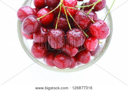4804 Cherry red with drops in a glass bowl on a white background - view from above