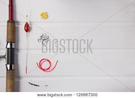 fishing gear on white rustic wood background