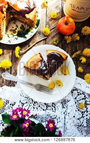 Traditional homemade chocolate cake. Rustic style and natural light. Chocolate Mud Cake on White table. Piece of chocolate cake with icing. Vanilla Cake with Chocolate Glaze.
