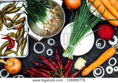 Onion beet pepper garlic carrot cabbage ready to prepare salad. Detox and diet food. Composition of organic veggies. Vegetable food background. Red and green veggies composition on a black table