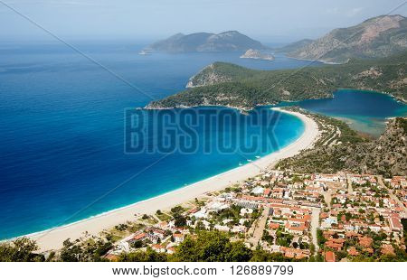 Town and beach on a coast of mediterranean sea. Oludeniz Fethiye Turkey.