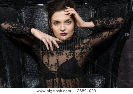 Girl Posing In A Big Black Leather Chair.