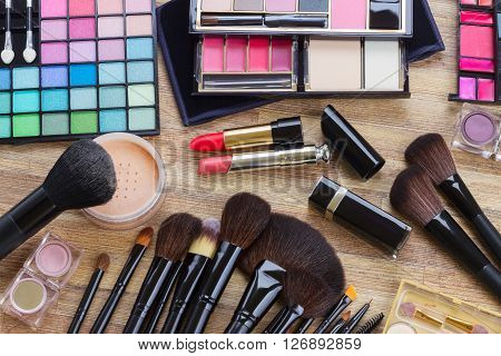 Set of professional  brushes, lipsticks, maskara, eye shadows and  powder, top view