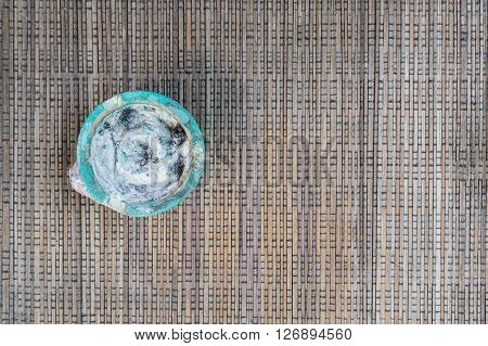Empthy ashtray on brown woven cloths on the left side