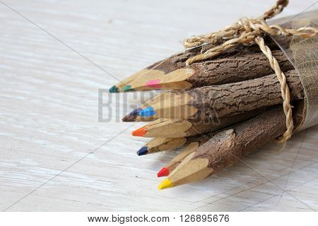 Wooden pencils on a white wooden table.
