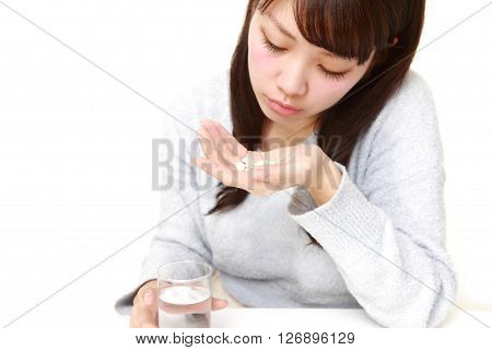 young Japanese woman suffers from melancholy on white background