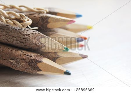 Wooden pencils on a white wooden table.