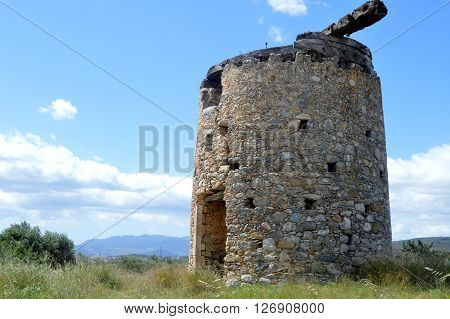 An old mill gets wind in Greece.