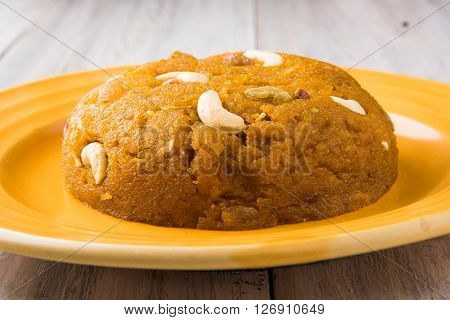 Moong Dal Halwa - a sweet dish from India, Indan Sweet Halwa made from Moong Dal, moong dal sweet sheera or shira cooked in pure ghee, served in a yellow ceramic plate