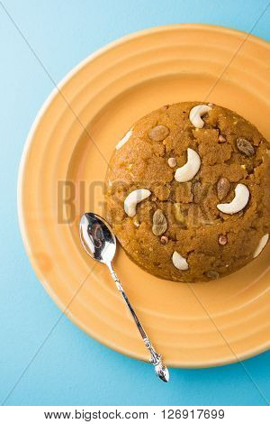Moong Dal Halwa - a sweet dish from India, Indan Sweet Halwa made from Moong Dal, moong dal sweet sheera or shira cooked in pure ghee, served in a yellow ceramic plate