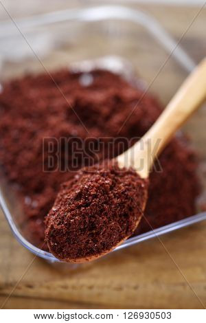 Middle Eastern spice Sumak in a wooden spoon. Selective focus on the spice in the spoon