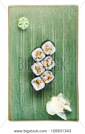 Sushi rolls with tuna and flying fish roe on a plate with wasabi and ginger. Top view. Isolated on white background. Include clipping path.