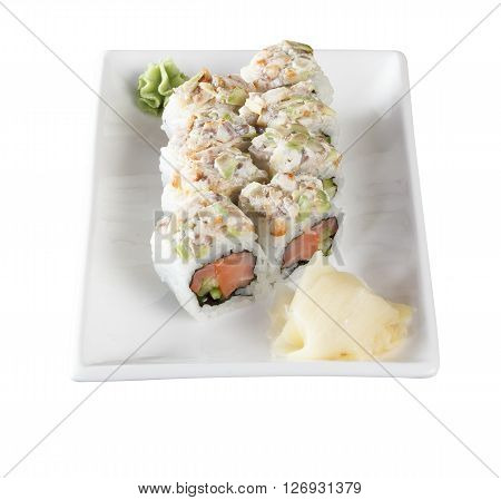 Sushi rolls with tuna and flying fish roe on a plate with wasabi and ginger. Top view. Isolated on white background. Include clipping path.