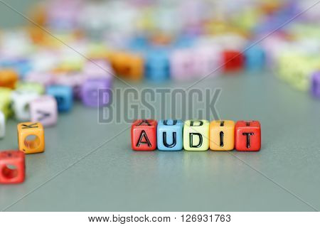 Close up of Audit word on colorful dices