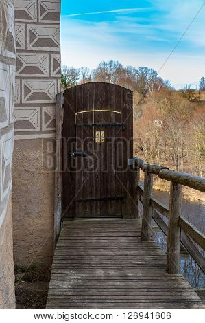 Old wooden door in medieval castle of Bauska town, Latvia