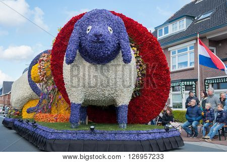 HILLEGOM, THE NETHERLANDS - APRIL 23, 2016: Platform with a frame made in a form of a sheep decorated with spring flowers. Taking part in the  traditional flowers parade 