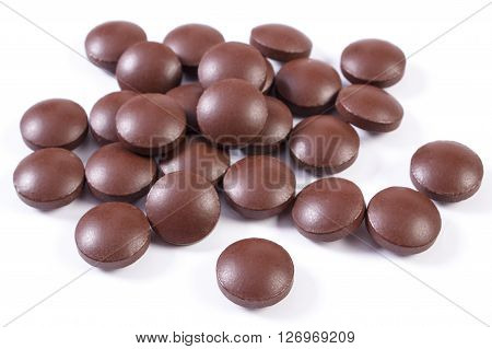 Heap of brown medical pills tablets capsules or supplements for therapy concept of treatment and health care