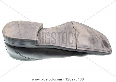 Damaged sole of a black shoe isolated