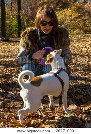 portrait of a woman with a dog on holiday in the autumn park  age of 40 years