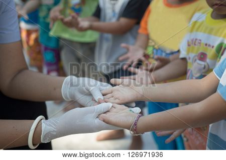 Yasothorn THAILAND DEC-01 : Health worker finding new case of Hand foot mouth disease in child on December 01,2015 at village in Yasothorn Thailand