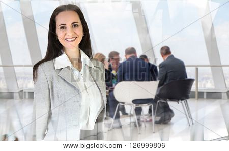 Attractive young woman in office against of glass reflection and business meeting going at the background