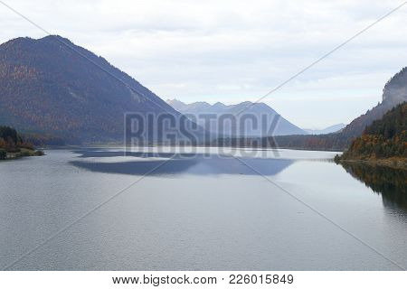A Beautiful Lake At Autumn In The Bavarian Mountains