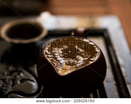 Green Tea Pouring With Drops In Traditional Chinese Tea Ceremony